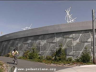 Textured concrete wall next to a bike path.